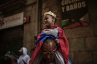 <p>A young boy dressing as a king of San Fermin takes part in a procession at the San Fermin Festival, in Pamplona, northern Spain, July 7, 2018. (Photo: Alvaro Barrientos/AP) </p>