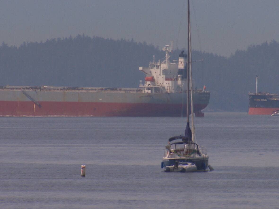 One of only two buoys marking the Kitsilano Beach swimming zone can be seen to the left of the sailboat. Swimmers say more are needed to keep motorized boats out of the swimming areas. (CBC - image credit)