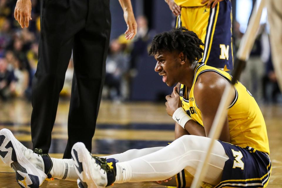 Michigan center Tarris Reed Jr. suffers from an injury during the second half against Wisconsin of U-M's 87-79 overtime win on Sunday, Feb. 26, 2023, at Crisler Center.