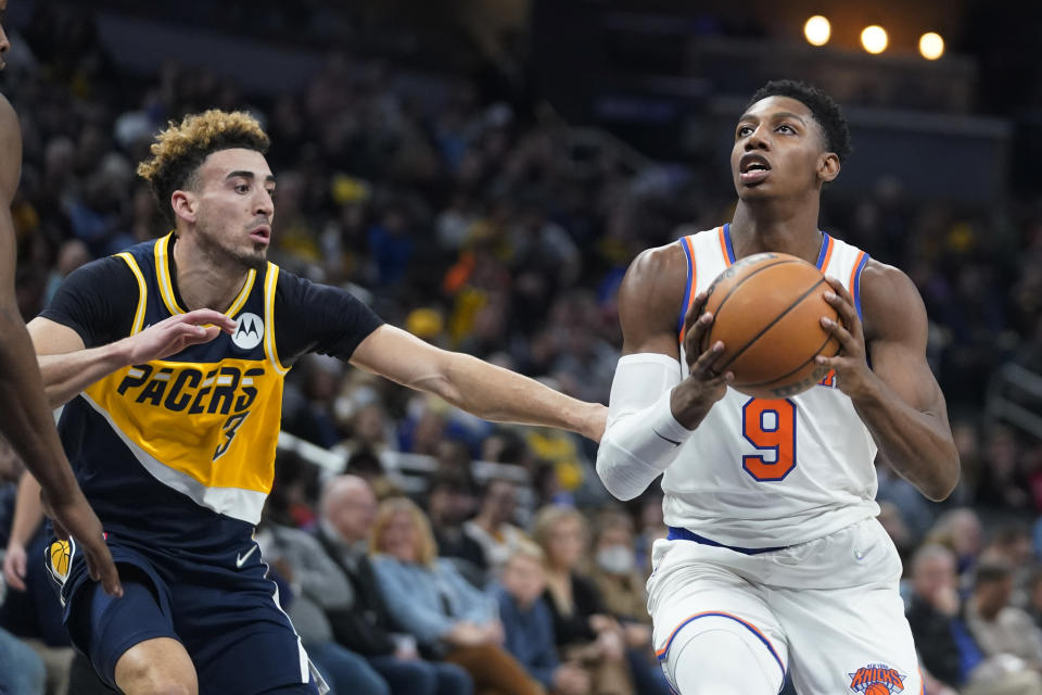 New York Knicks' RJ Barrett (9) is defended by Indiana Pacers' Chris Duarte (3) during the first half of an NBA basketball game Wednesday, Dec. 8, 2021, in Indianapolis. (AP Photo/Darron Cummings)