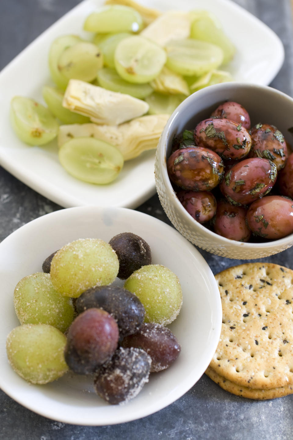 This Nov. 4, 2013 photo shows sugared grapes, marinated olives, and grapes with artichoke hearts in Concord, N.H. (AP Photo/Matthew Mead)