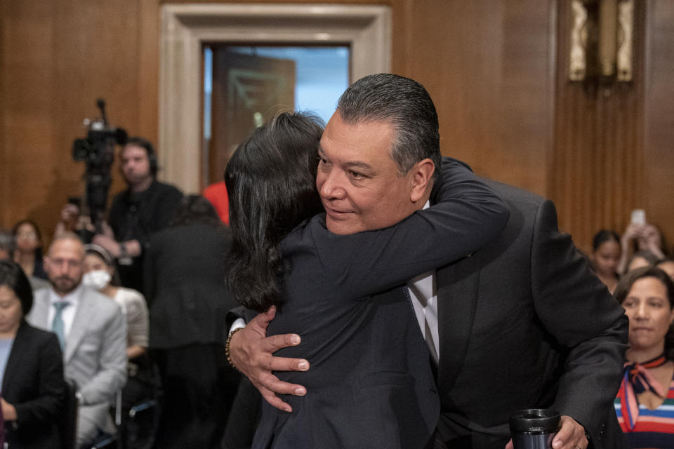 Julie Su, left, hugs Sen. Alex Padilla, D-Calif., who spoke on her behalf, before a Senate Health, Education, Labor and Pensions confirmation hearing for her to be the Labor Secretary, on Capitol Hill, Thursday, April 20, 2023, in Washington. (AP Photo/Alex Brandon)