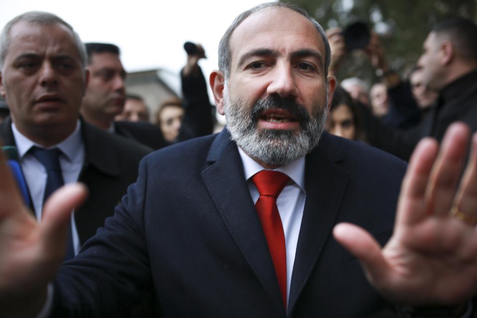 Acting Armenian Prime Minister Nikol Pashinian gestures as he leaves a polling station during an early parliamentary election in Yerevan, Armenia, Sunday, Dec. 9, 2018. The charismatic 43-year-old Nikol Pashinian took office in May after spearheading massive protests against his predecessor's power grab that forced the politician to step down. (Vahan Stepanyan, PAN Photo via AP)