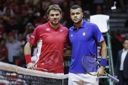 France's Jo-Wilfried Tsonga (R) and Switzerland's Stanislas Wawrinka pose before their Davis Cup final singles match at the Pierre-Mauroy stadium in Villeneuve d'Ascq, near Lille, November 21, 2014. REUTERS/Gonzalo Fuentes