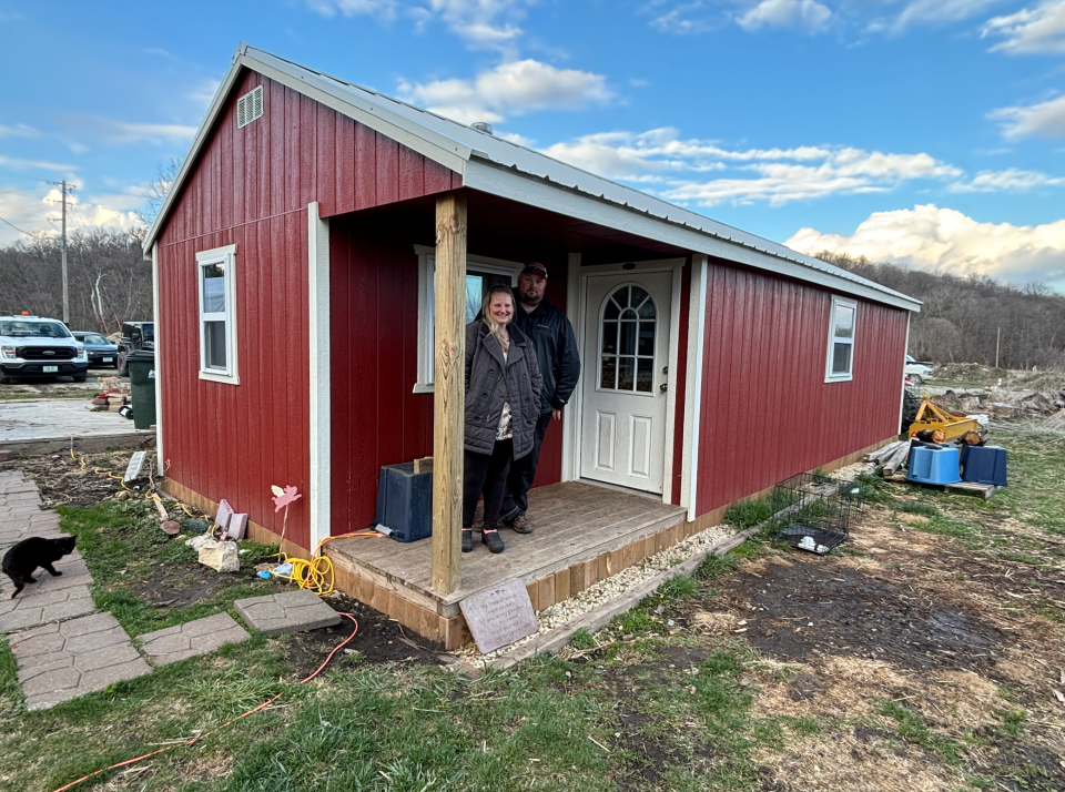 Ryan and Mandy Gainuss stand in front of their shed that they have called home since they demolished their home after the 2022 Winterset tornado.