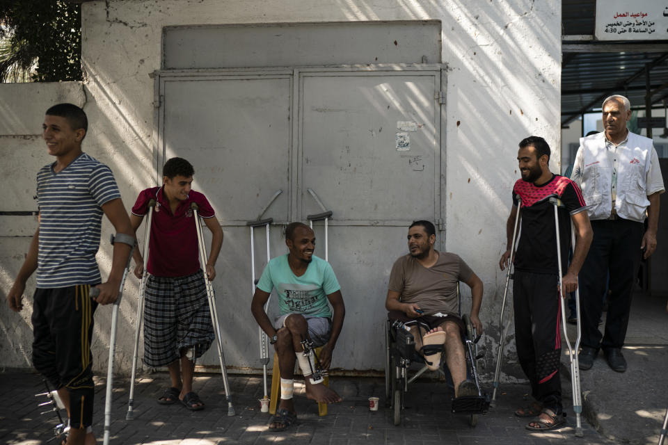 In this Sept. 10, 2018, photo, patients with leg injuries they attained during demonstrations, gather outside a clinic run by MSF (Doctors Without Borders) in Gaza City. Ever since Hamas launched demonstrations in March against Israel's blockade of Gaza, children have been a constant presence in the crowds. Since then, U.N. figures show that 948 children under 18 have been shot by Israeli forces and 2,295 have been hospitalized, including 17 who have had a limb amputated. (AP Photo/Felipe Dana)