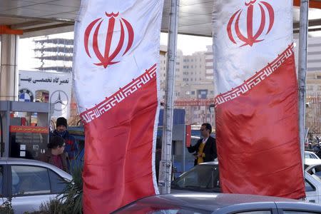 Iranian flags are seen at a petrol station in Tehran, Iran, January 25, 2016. REUTERS/Raheb Homavandi/TIMA