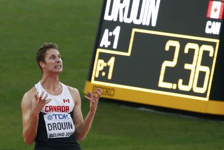 Derek Drouin of Canada celebrates after winning gold in the men's high jump final during the 15th IAAF World Championships at the National Stadium in Beijing, China August 30, 2015. REUTERS/David Gray