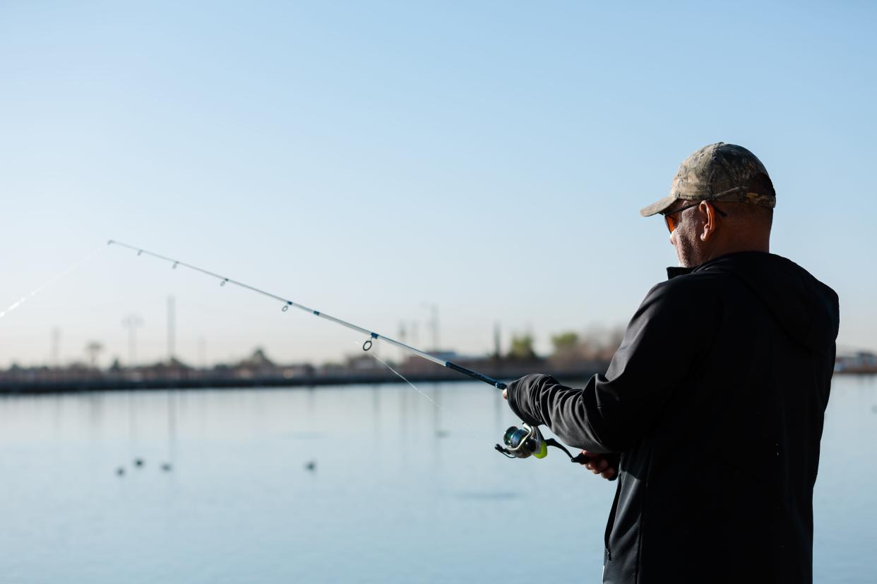 A man spends time fishing at Ascarate Lake early Saturday morning, March 19, 2022.