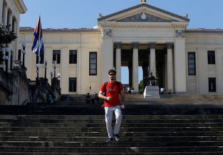 Miguel Hayes, who writes for the blog La Joven Cuba, walks down the staircase of the University of Havana, in Havana, Cuba February 5, 2018. REUTERS/Stringer