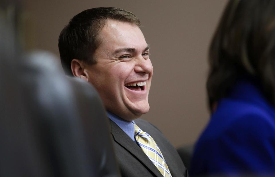 FILE - In this Oct. 10, 2012 file photo, Carl DeMaio laughs during a city council meeting in San Diego. The GOP’s formal platform, as set in its 2012 national convention, declares that “marriage, the union of one man and one woman, must be upheld as the national standard.” Republican opposition to gay marriage has become less visible recently, however, as the GOP works to improve its image and polling suggests that most Americans support same-sex marriage. DeMaio is challenging first-term Democratic Rep. Scott Peters. During his unsuccessful 2012 Republican mayoral campaign, DeMaio and his male partner of six years were booed as they walked hand-in-hand in San Diego’s gay pride parade. (AP Photo/Gregory Bull, File)