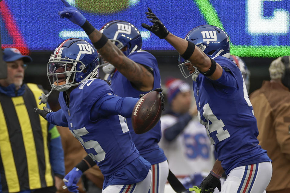 New York Giants cornerback Deonte Banks (25) celebrates with teammates after intercepting pass against the New England Patriots during the first quarter of an NFL football game, Sunday, Nov. 26, 2023, in East Rutherford, N.J. (AP Photo/Adam Hunger)