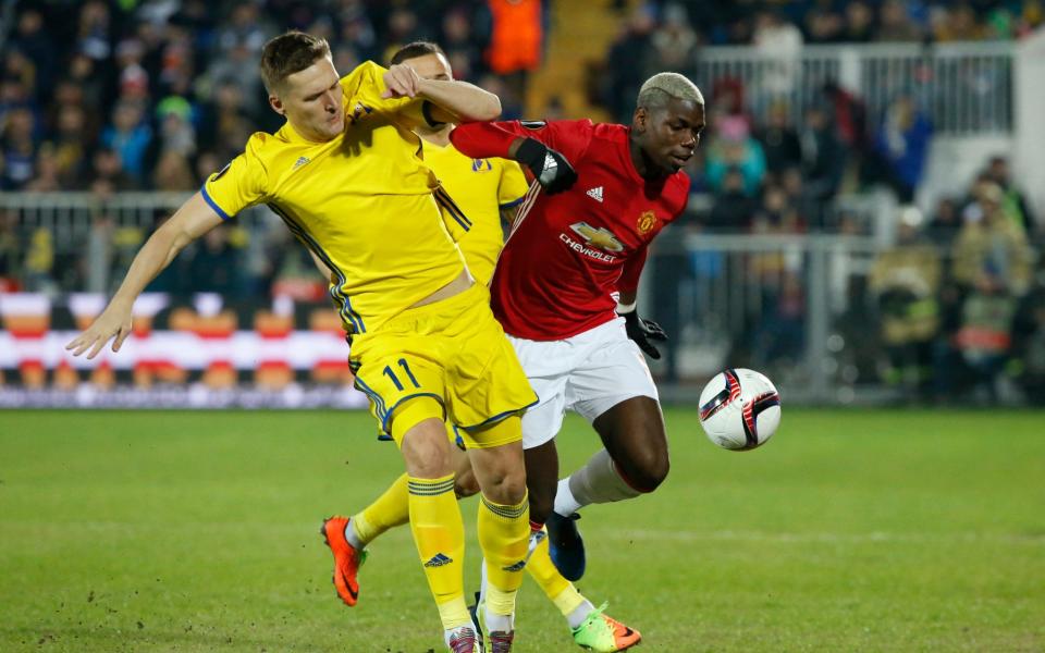 <p>Manchester United’s Paul Pogba, right, and Rostov’s Christian Noboa fight for the ball </p>