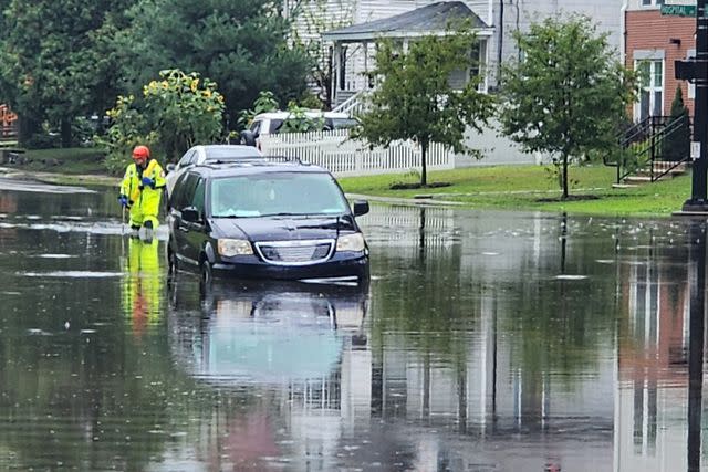 <p>Danbury Fire Department/Facebook</p> A car stalled in floodwaters in Dabury, Conn., after tropical downpours on Sunday, Aug. 18, 2024