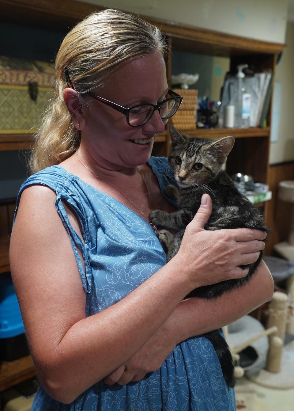 Lisa Donadio of Pomona holds a kitten at the Four Legs Good shelter in New City on Thursday, July 13, 2023.