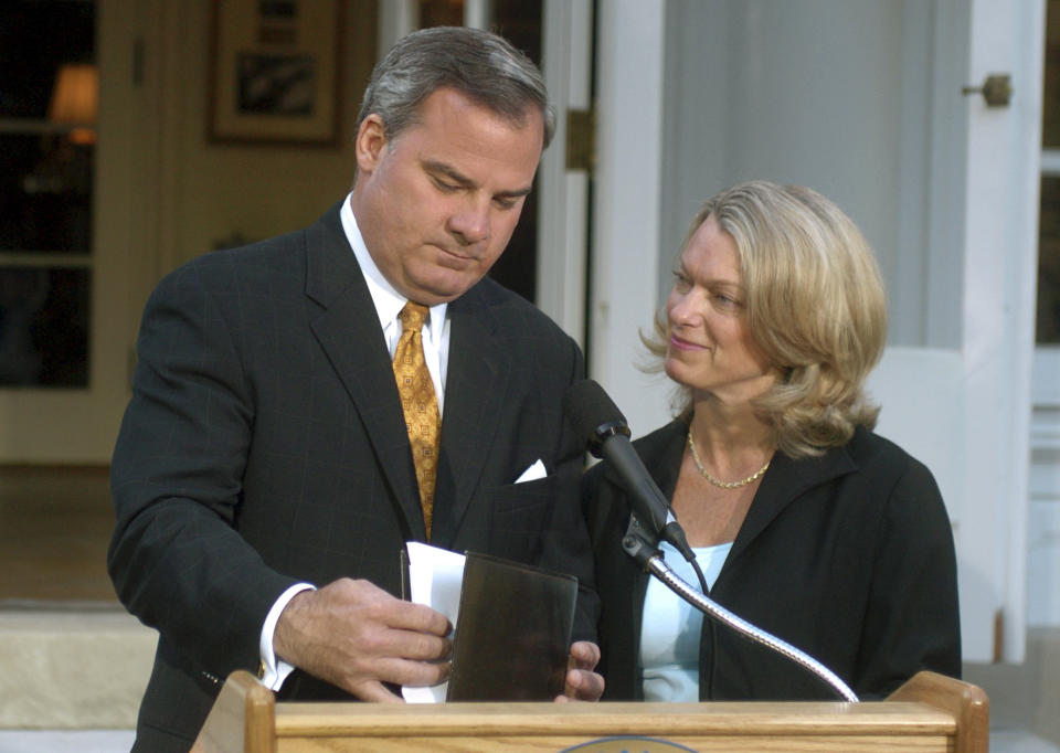 FILE - In this June 21, 2004 file photo, Connecticut Gov. John G. Rowland, with his wife Patty beside him, finishes his speech after he announced his resignation from office at the Governor's Residence in Hartford, Conn. Rowland eventually was sentenced to serve time in a federal prison, but again is in the crosshairs of federal investigators. On Monday, March 31, 2014, a former Republican Congressional candidate and her husband pleaded guilty in a scheme to create a phony contract to hide the consulting role Rowland played in her campaign. (AP Photo/Bob Child, File)