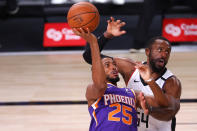 Patrick Patterson, right, of the Los Angeles Clippers, defends a shot from Mikal Bridges, left, of the Phoenix Suns during an NBA basketball game Tuesday, Aug. 4, 2020, in Lake Buena Vista, Fla. (Kevin C. Cox/Pool Photo via AP)