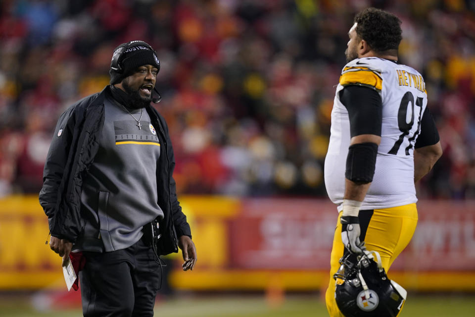 Pittsburgh Steelers head coach Mike Tomlin talk with defensive end Cameron Heyward (97) during the second half of an NFL wild-card playoff football game against the Kansas City Chiefs, Sunday, Jan. 16, 2022, in Kansas City, Mo. (AP Photo/Ed Zurga)