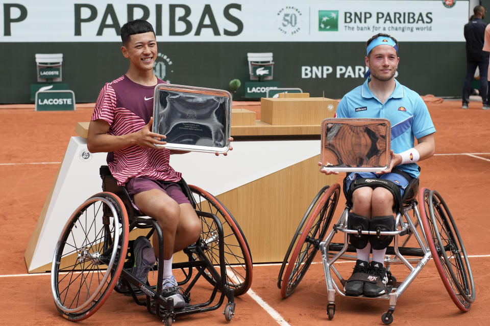 Champion Japan's Tokito Oda, left, and runner-up Britain's Alfie Hewett pose with thir trophies after the final match of the Men's Wheelchair Singles French Open tennis tournament at the Roland Garros stadium in Paris, Saturday, June 10, 2023. (AP Photo/Christophe Ena)