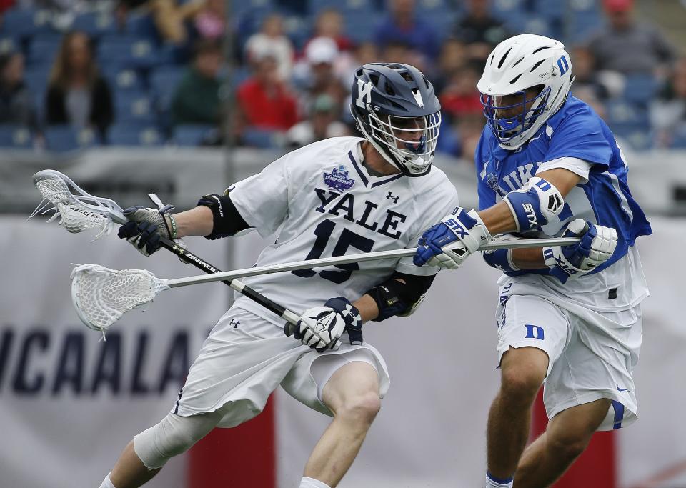 FILE - In this May 28, 2018, file photo, Yale's Jackson Morrill (15), left, is defended by Duke's Kevin McDonough during the first half of an NCAA college Division I championship final lacrosse game, in Foxborough, Mass. The Ivy League has decided not to allow its spring-sport athletes who had their seasons shortened by the coronavirus pandemic to have an additional year of eligibility, despite the NCAA granting that option earlier this week. The move, which was announced Thursday, April 2, 2020, was consistent for the Ivy League, which hasn't allowed athletes who received medical redshirts to play for a fifth year. Yale is an Ivy League school. (AP Photo/Michael Dwyer, File)