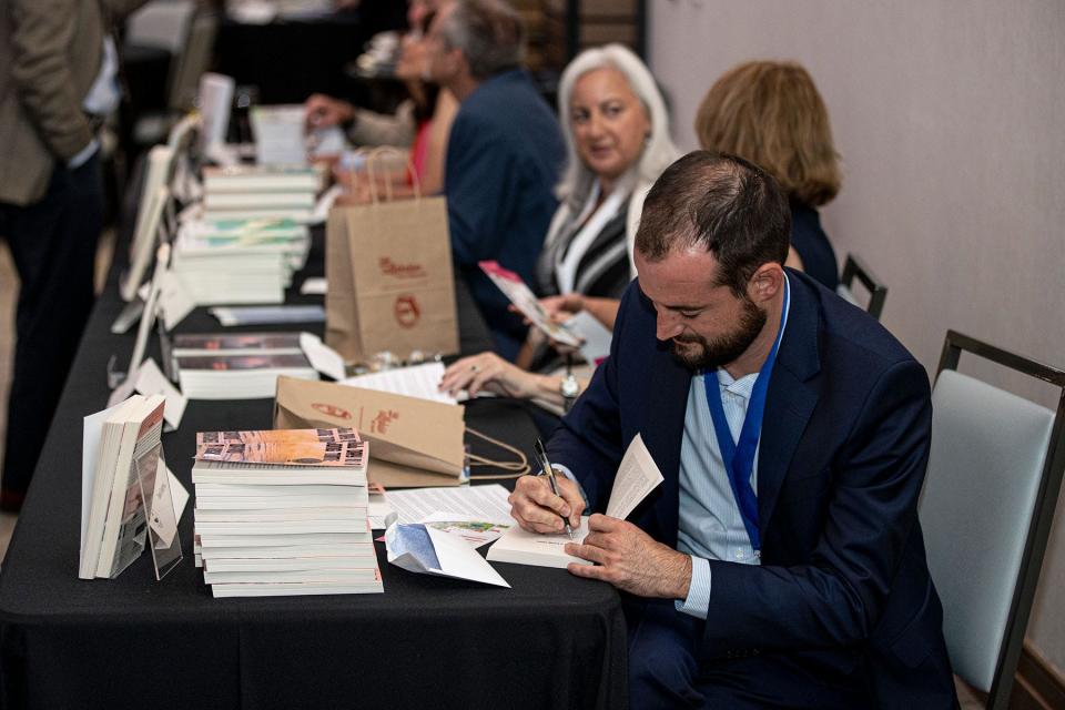 Florida Book Award winners signing books at the 2022 awards ceremony.