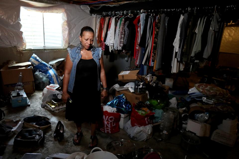 Flood victim Alecia Green of Detroit in her water logged basement on Thursday, July 1, 2021.