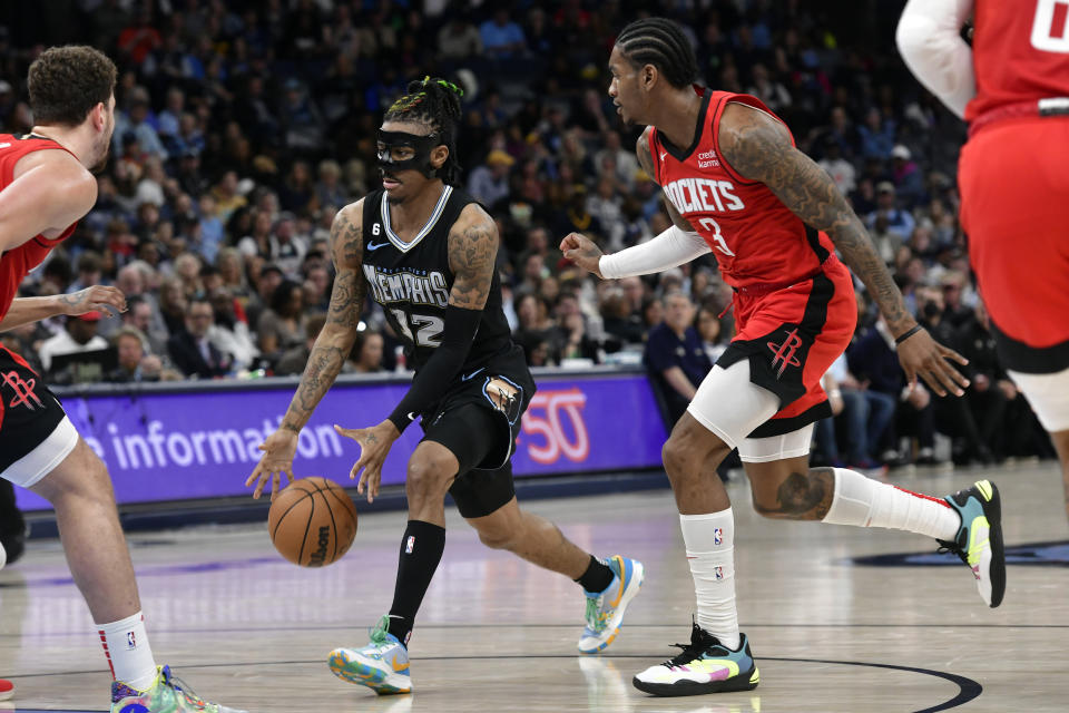 Memphis Grizzlies guard Ja Morant (12) drives ahead of Houston Rockets guard Kevin Porter Jr. (3) in the second half of an NBA basketball game Friday, March 24, 2023, in Memphis, Tenn. (AP Photo/Brandon Dill)