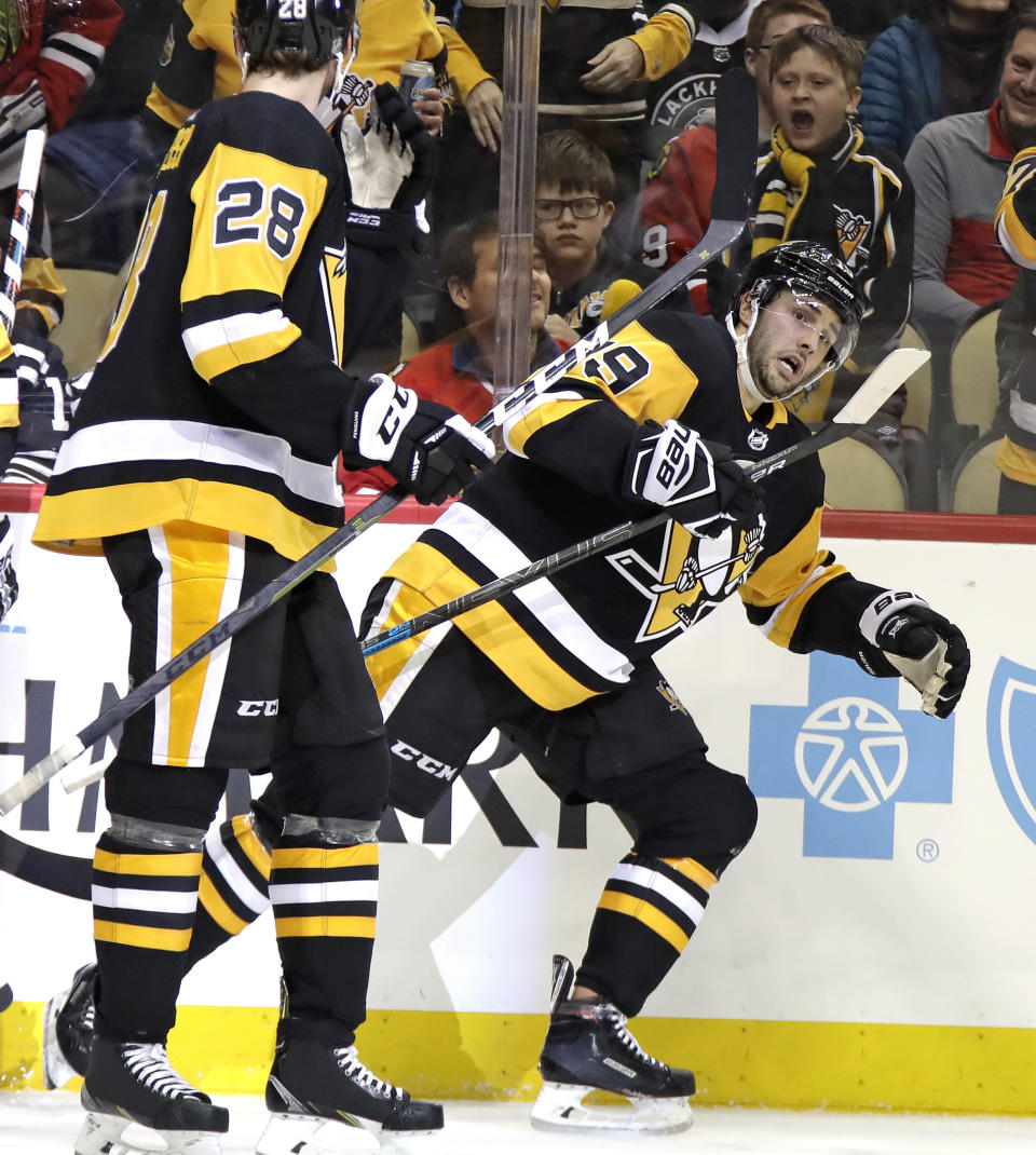 Pittsburgh Penguins' Derick Brassard (19) heads back to his bench after scoring during the second period of an NHL hockey game against the Chicago Blackhawks in Pittsburgh, Sunday, Jan. 6, 2019. (AP Photo/Gene J. Puskar)