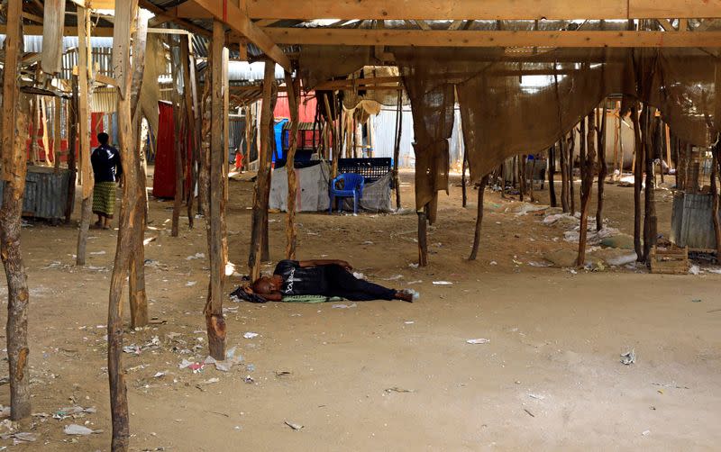 A Somali man sleeps at an abandoned khat stimulant market closed amid concerns about the spread of coronavirus disease (COVID-19), in Mogadishu