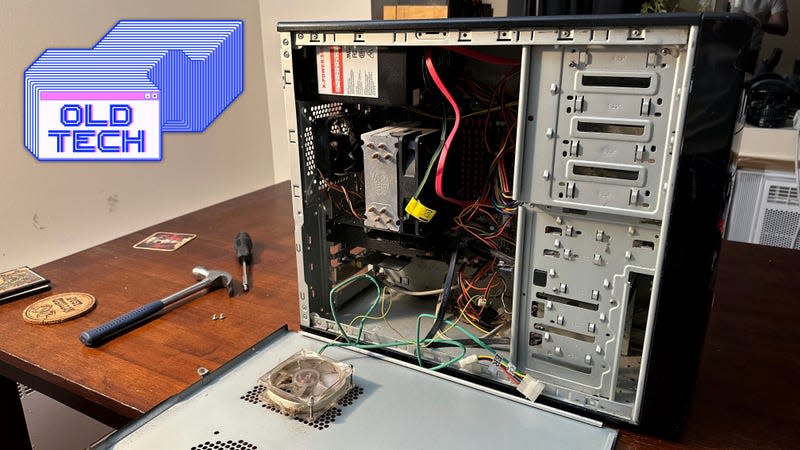 An open PC tower full of dust containing wires and several fans.