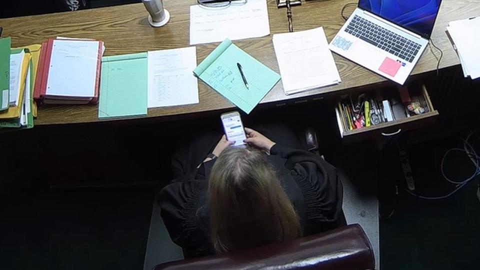 PHOTO: Then-Lincoln County District Judge Traci Soderstrom is seen looking at her cellphone during a murder trial on June 8, 2023, in this still image from security camera video. (Lincoln County Sheriff's Office)
