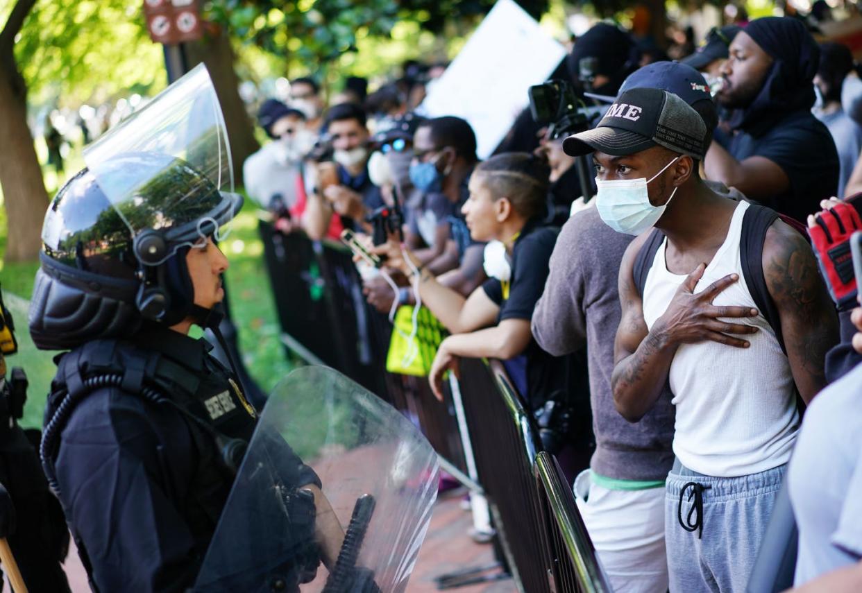 <span class="caption">Protesters against racist police violence encounter police in Washington, D.C., on May 31.</span> <span class="attribution"><a class="link " href="https://www.gettyimages.com/detail/news-photo/demonstrators-protesting-the-death-of-george-floyd-talk-to-news-photo/1216617277" rel="nofollow noopener" target="_blank" data-ylk="slk:Mandel Ngan/AFP via Getty Images;elm:context_link;itc:0;sec:content-canvas">Mandel Ngan/AFP via Getty Images</a></span>