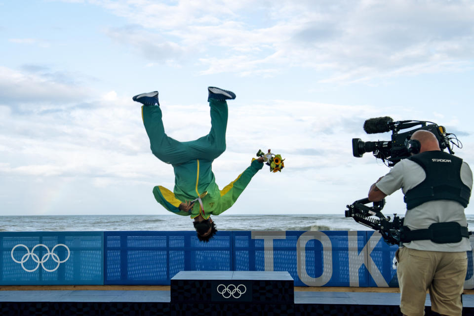 Brazil's Italo Ferreira celebrates after winning the gold medal in the men's surfing competition at the 2020 Summer Olympics, Tuesday, July 27, 2021, at Tsurigasaki beach in Ichinomiya, Japan. (Olivier Morin/Pool Photo via AP)