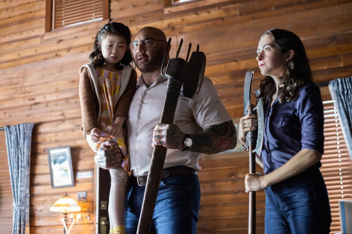 From left, Kristen Cui, Dave Bautista and Abby Quinn in Knock at the Cabin (Universal Studios)