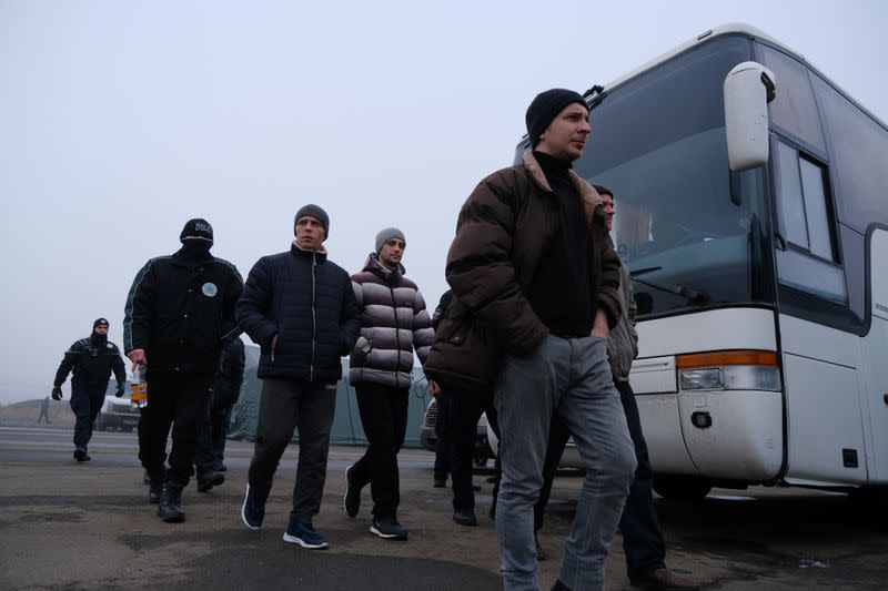Men board buses for pro-Russian rebels before prisoner of war exchange in Donetsk region