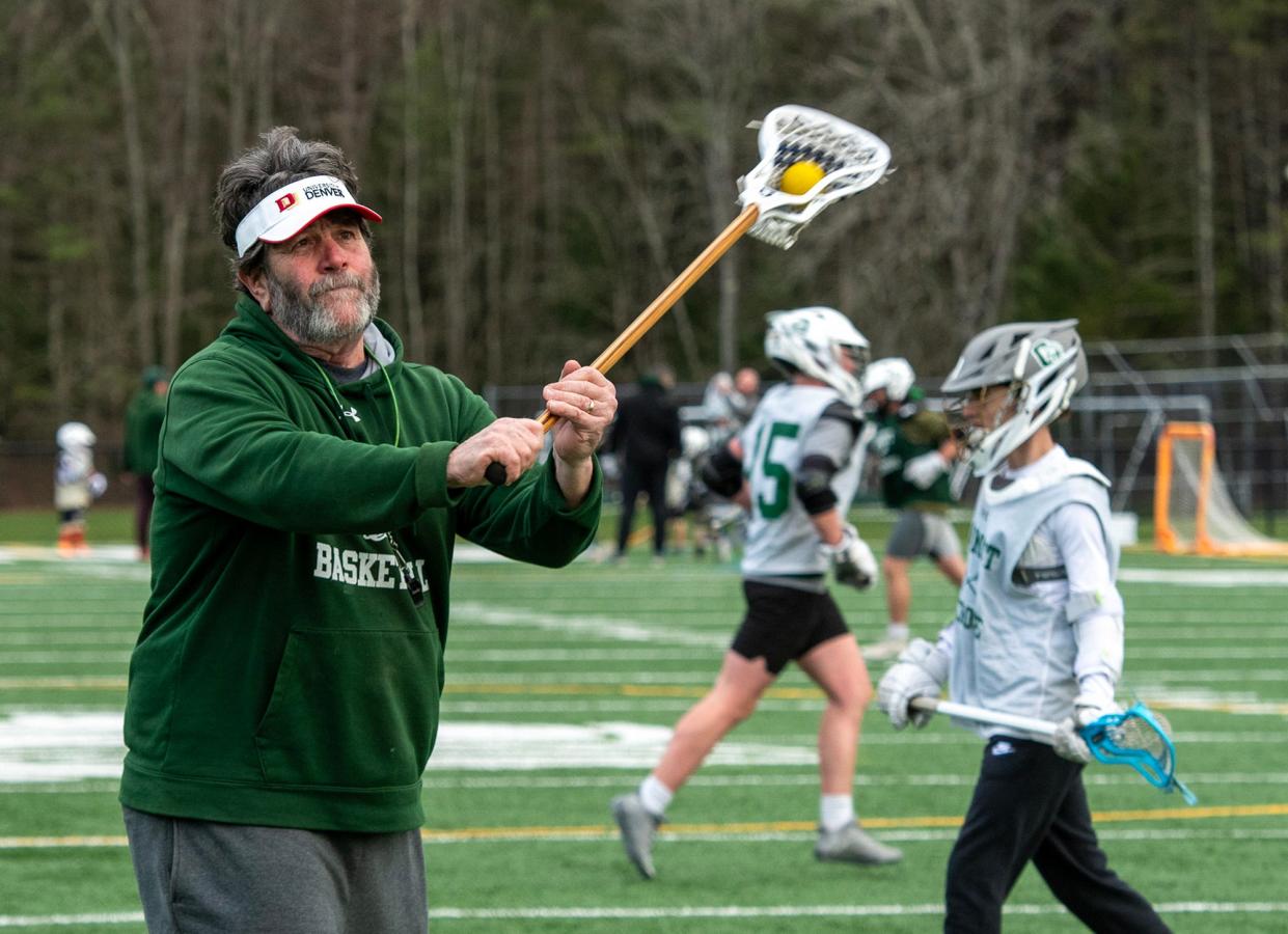 Oakmont Regional High School assistant lacrosse coach Brian Billings works with goalies during practice at the school Wednesday.