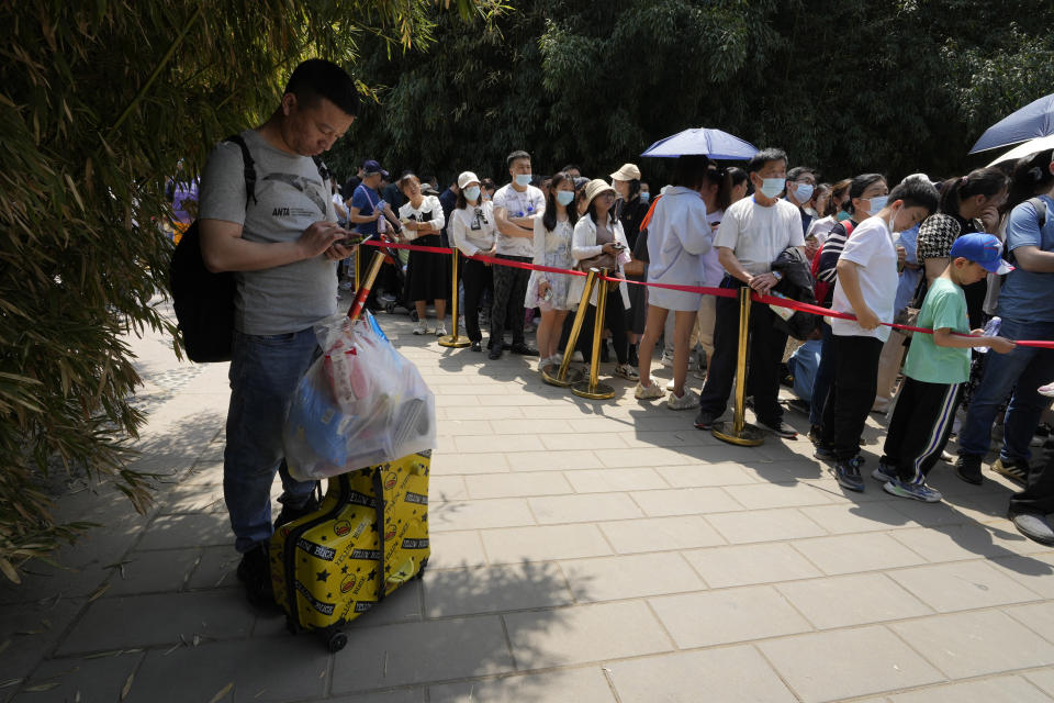 Visitors line up to visit the Panda enclosure in the zoo on the last day of the May Day holidays in Beijing, Wednesday, May 3, 2023. (AP Photo/Ng Han Guan)