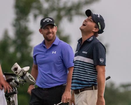 Apr 30, 2017; Avondale, LA, USA; Scott Brown (left) and Kevin Kisner (right) share a laugh on the 18th hole during the final round of the Zurich Classic of New Orleans golf tournament at TPC Louisiana. Stephen Lew-USA TODAY Sports