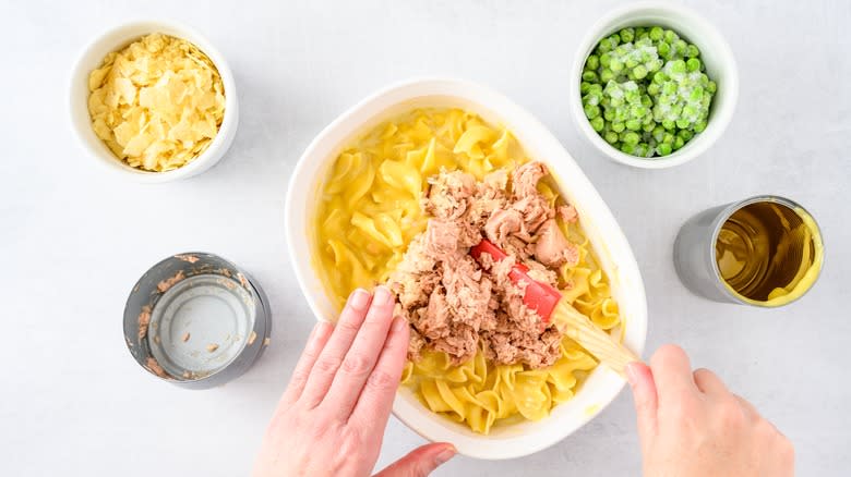 mixing tuna casserole ingredients in dish