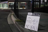 A sign sits just outside the property line for Boeing's Renton factory as a security guard stands behind a fence as Boeing workers picket after union members voted overwhelmingly to reject a contract offer and go on strike Friday, Sept. 13, 2024, in Renton, Wash. (AP Photo/Lindsey Wasson)