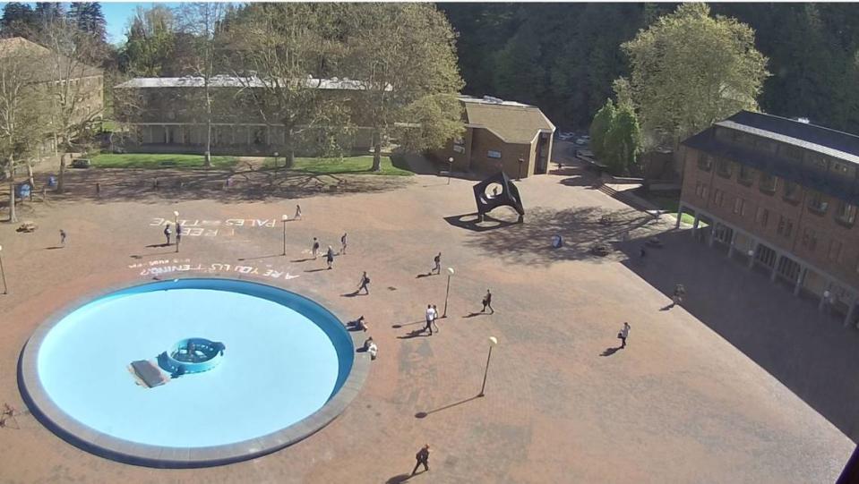 “Are you listening?” and “Free Palestine” are written in chalk on the bricks at Red Square in a screenshot from a live video stream on May 9 at the campus of Western Washington University.