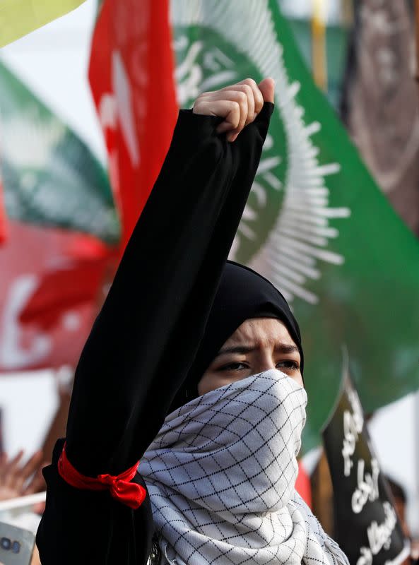 A Pakistani Shi'ite Muslim chant slogans with others to protest the death of Iranian military commander Qassem Soleimani, who was killed in a airstrike near Baghdad, as they march on a road leading towards the U.S. consulate in Karachi