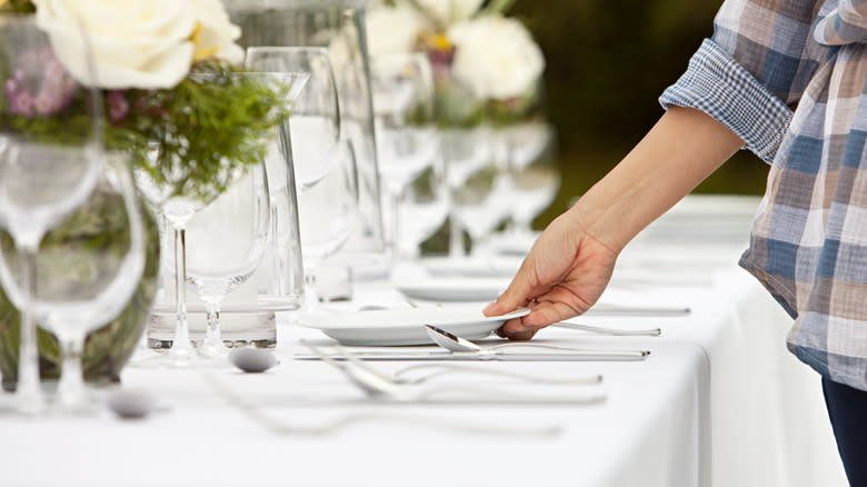 Person setting a table