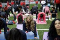 <p>A Houston Texans cheerleader takes part in a yoga class at the Angel of Independence monument in Mexico City, Sunday, Nov. 20, 2016. The Texans face the Oakland Raiders in an NFL football game in Mexico City on Nov. 21. (AP Photo/Gregory Bull) </p>