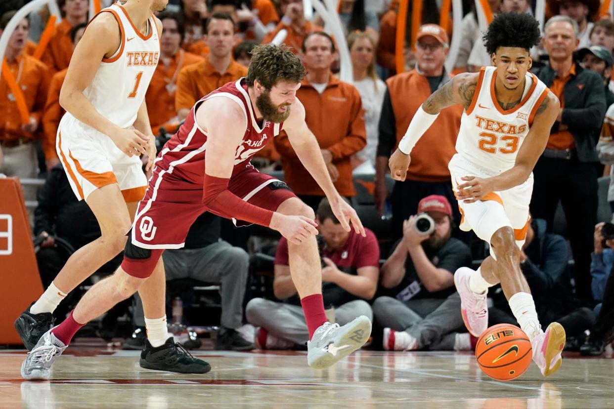 Oklahoma's Tanner Groves and Texas' Dillon Mitchell chase a loose ball during Saturday's 85-83 Longhorns victory at Moody Center. With the win in its first Big 12 overtime game of the season, Texas remained tied atop the conference standings.