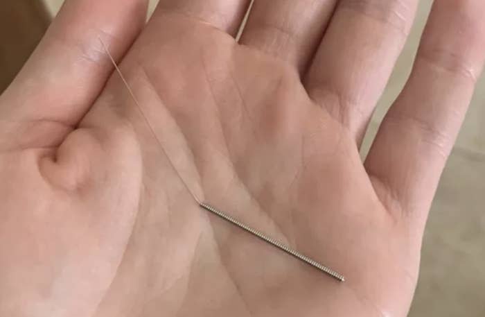 needle in the person's palm