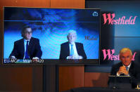 Westfield Chairman and co-founder Frank Lowy speaks via video-link as his sons Peter and Steven Lowy listen on during a media conference in Sydney, Australia, December 12, 2017. REUTERS/David Gray