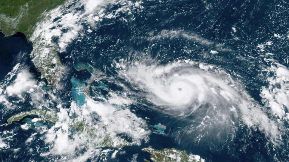 This GOES-16 satellite image taken Friday, Aug. 30, 2019, at 17:20 UTC and provided by National Oceanic and Atmospheric Administration (NOAA), shows Hurricane Dorian, right, moving over open waters in the Atlantic Ocean. Forecasters are now saying Dorian could be a Category 4 with winds of nearly 140 mph (225 kph) when it is forecasted to hit Florida late Monday or early Tuesday. It’s also imperiling the Bahamas, where the storm is expected to hit by Sunday. (NOAA via AP)