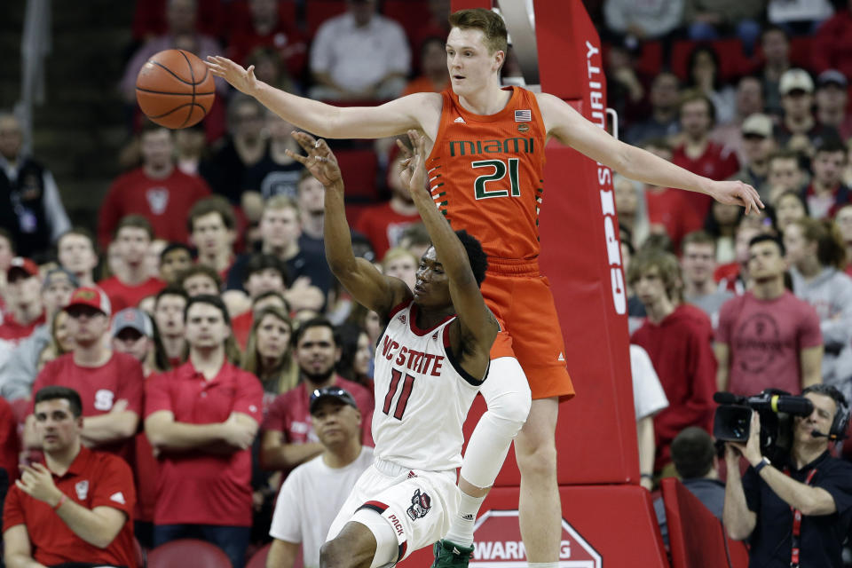 Miami forward Sam Waardenburg (21) blocks North Carolina State guard Markell Johnson (11) during the second half of an NCAA college basketball game in Raleigh, N.C., Wednesday, Jan. 15, 2020. (AP Photo/Gerry Broome)