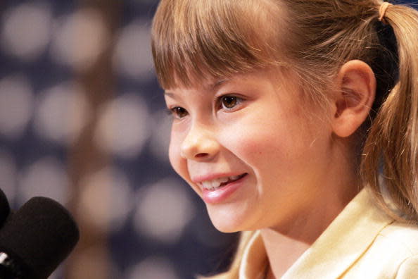 Washington, UNITED STATES: Bindi Irwin, daughter of Steve Irwin, the late “Crocodile Hunter” makes remarks during a Newsmakers Luncheon 19 January, 2007 at the National Press Club in Washington, DC. The eight-year-old daughter of Steve Irwin took part in a high-profile promotional US tour this week, but she will not be forced to perform, her manager said. Bindi Irwin, whose wildlife television star father was killed by a stingray barb last September, will visit Los Angeles and New York as part of Tourism Australia’s “G’Day USA” week to promote the country. She is also doing her own wildlife series, “Bindi the Jungle Girl”, for the American Discovery Channel. AFP PHOTO/Tim Sloan (Photo credit should read TIM SLOAN/AFP via Getty Images)